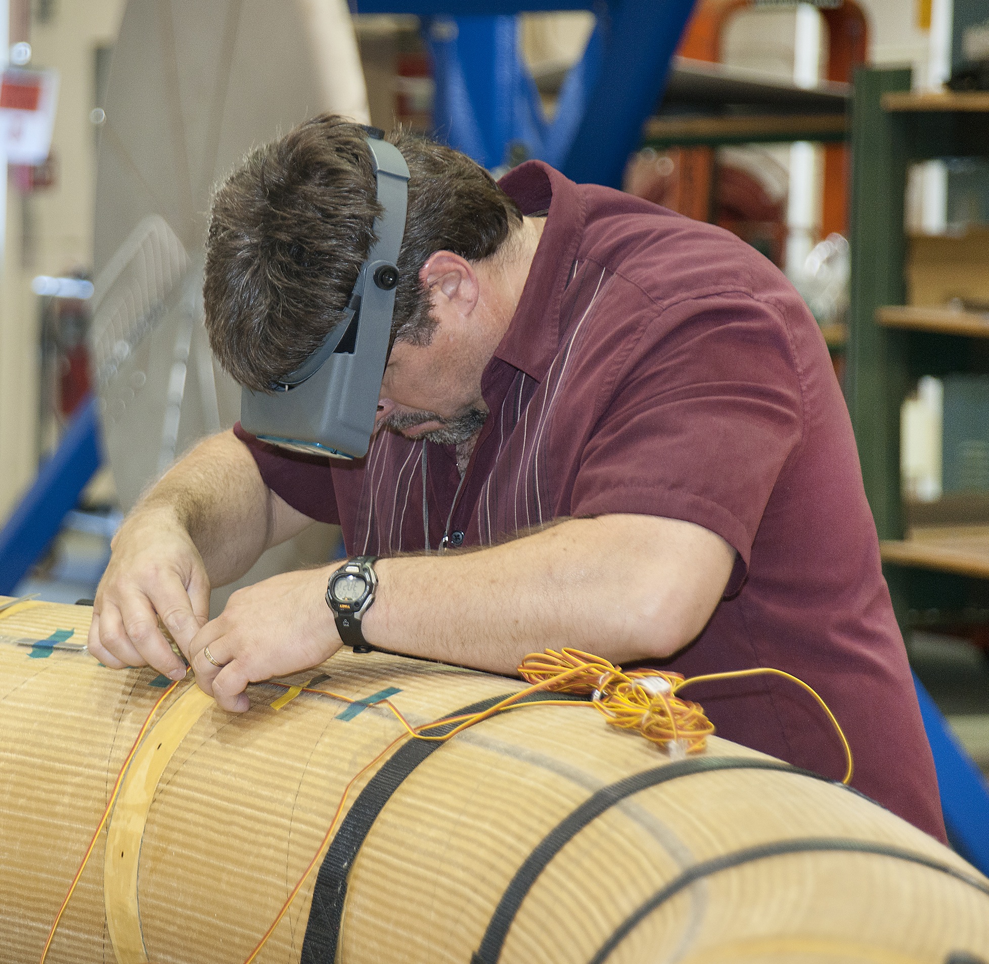 Instrumentation specialist Anthony Piazza carefully installs strain sensors on one of the Hypersonic Inflatable Aerodynamic Decelerator, or HIAD, test articles during a 2013 test series.