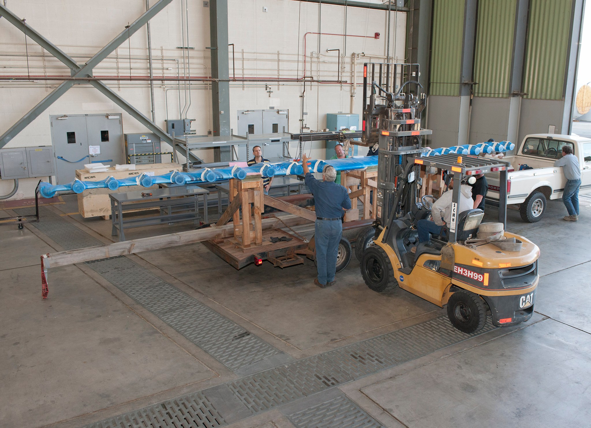 Technicians unload the LEAPTech experimental wing upon its arrival at NASA Armstrong Flight Research Center.