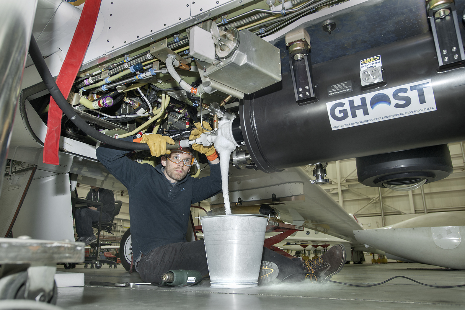 Neil Humpage, an investigator from University of Leicester, services the GHOST instrument with cryogenic liquid.