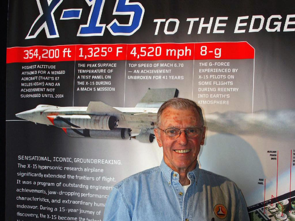 Joe Engle standing in front of the X-15 exhibit.