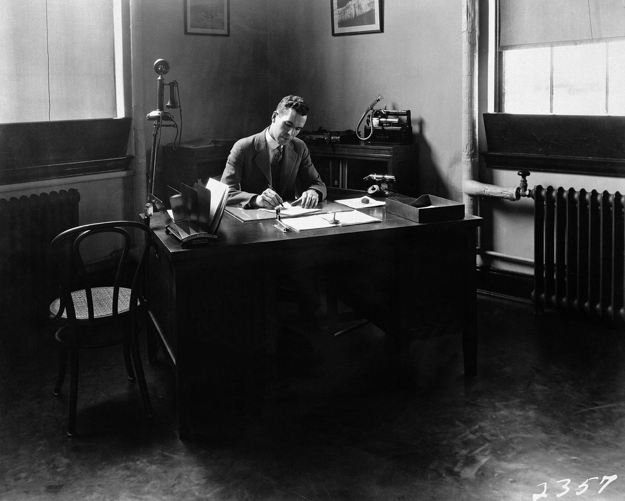 The youthful engineer-in-charge Henry Reid works at his desk, April 1928.
