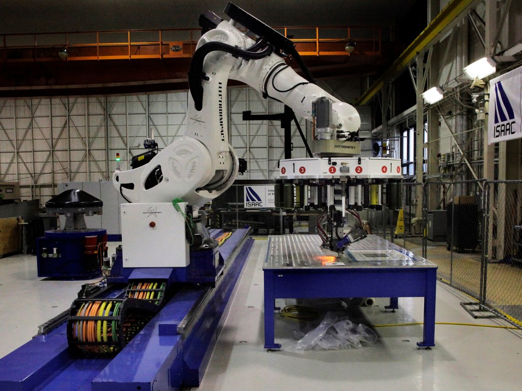 ISAAC can fuse ribbons of carbon fiber and epoxy into sheets of material following precise, sometimes curving patterns.