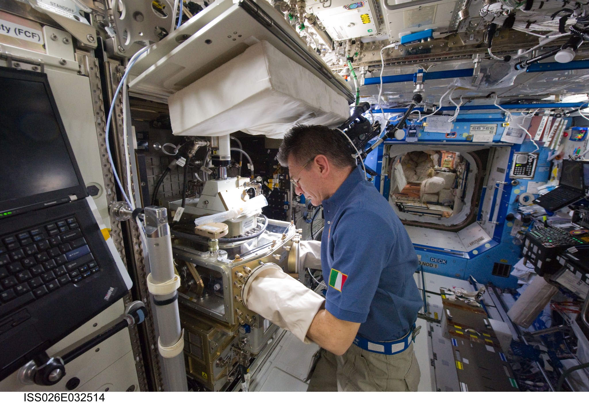 European Space Agency astronaut Paolo Nespoli operating the Light Microscopy Module microscope aboard the International Space St