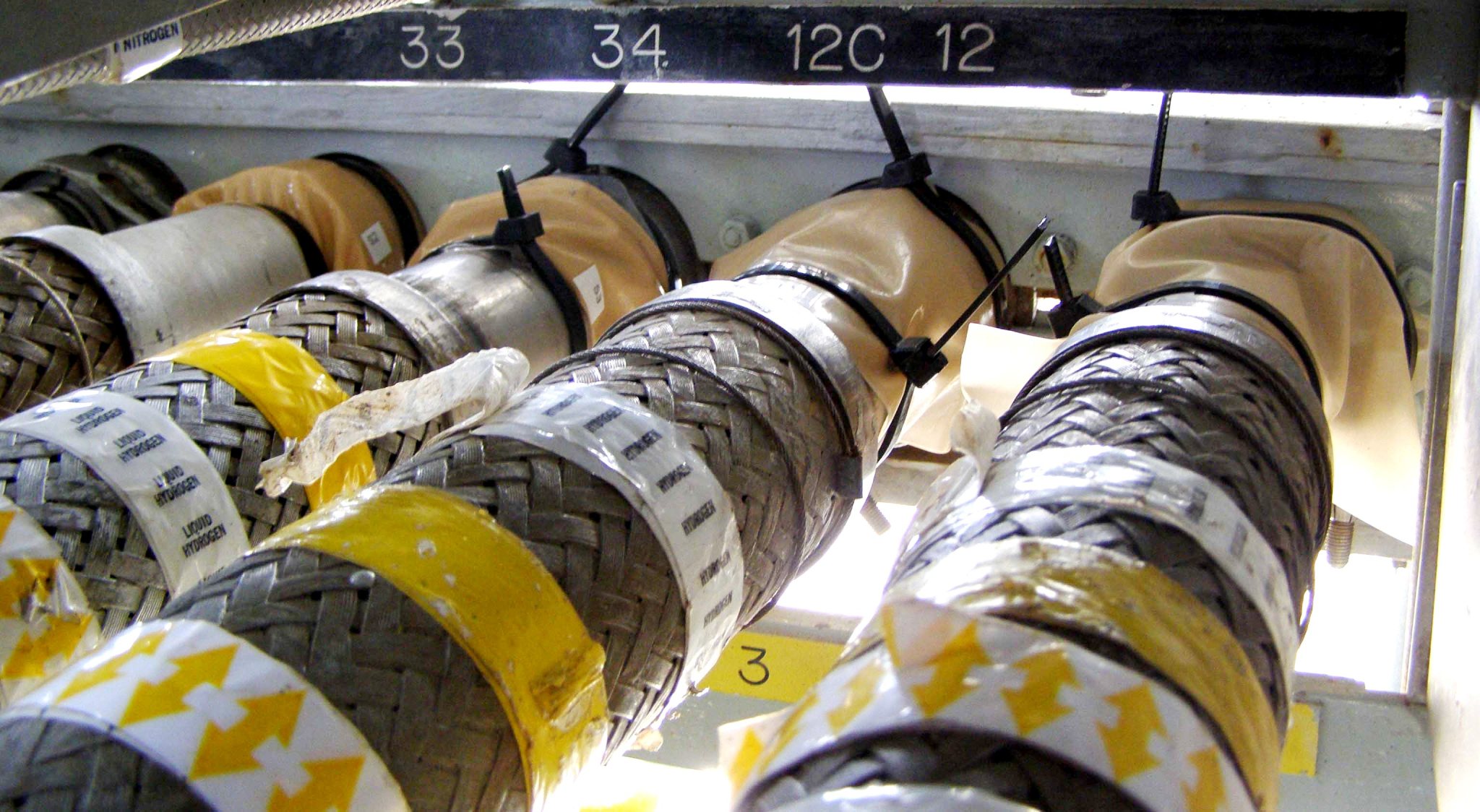 Connectors that feed liquid hydrogen into a spacecraft's fuel cells at Kennedy Space Center's Launch Pad 39A.