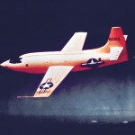The Bell X-1 painted in a red color is in flight.