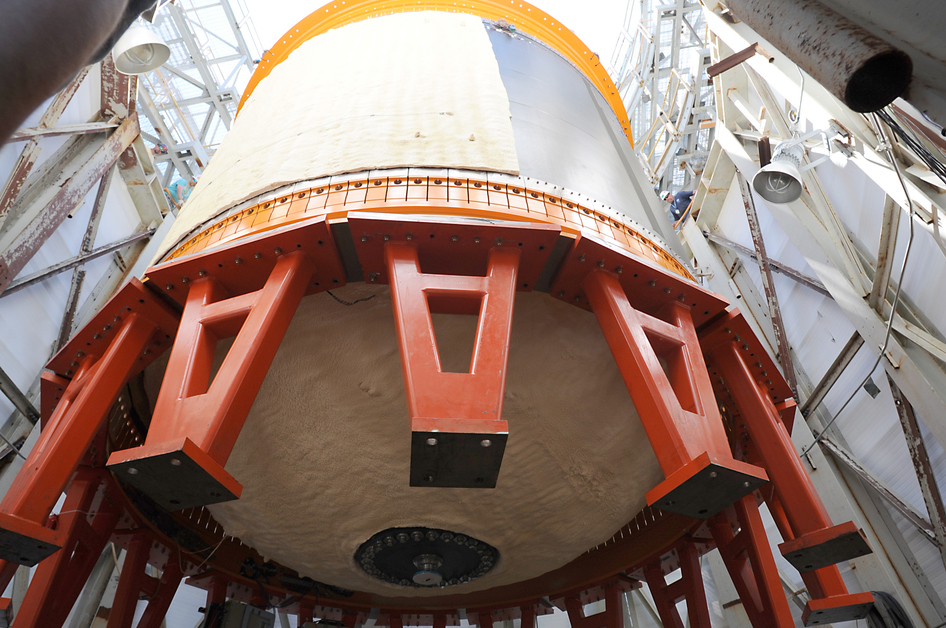 18-foot-diameter (5.5-meter) composite cryotank is lowered into a structural test stand at Marshall Space Flight Center.