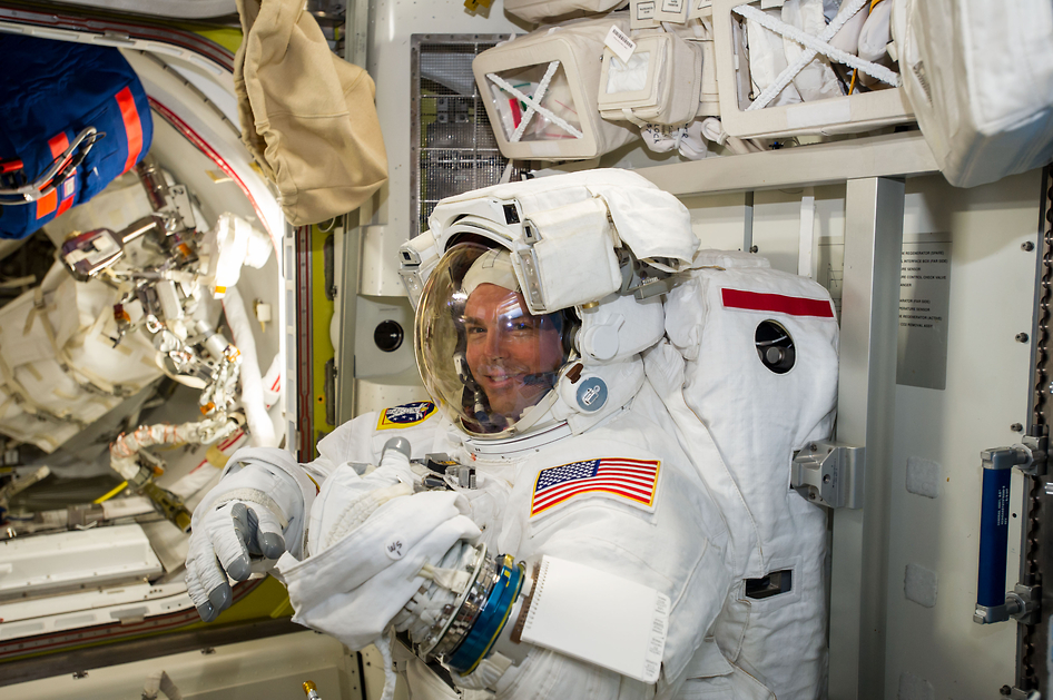 NASA astronaut Reid Wiseman checks his spacesuit in preparation for the first Expedition 41 spacewalk.
