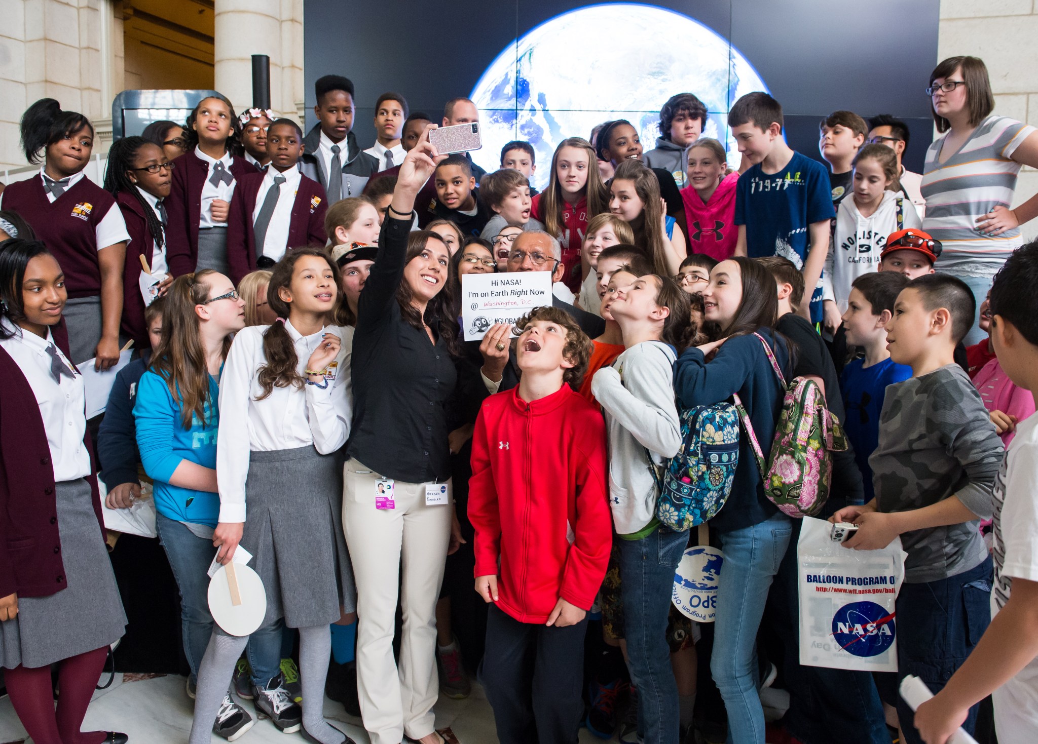 NASA Administrator Charles Bolden poses for a quick selfie with students who attended the NASA sponsored Earth Day event.