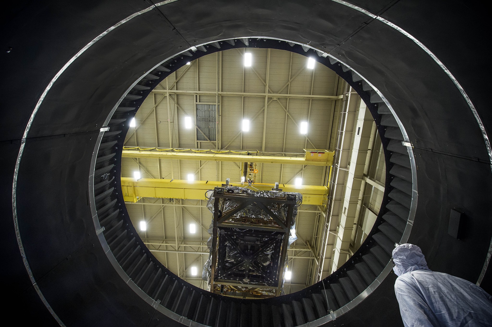 The view from inside NASA Goddard's Thermal Vacuum Chamber shows the JWST heart being lowered by crane in preparation of weeks of space environment testing.