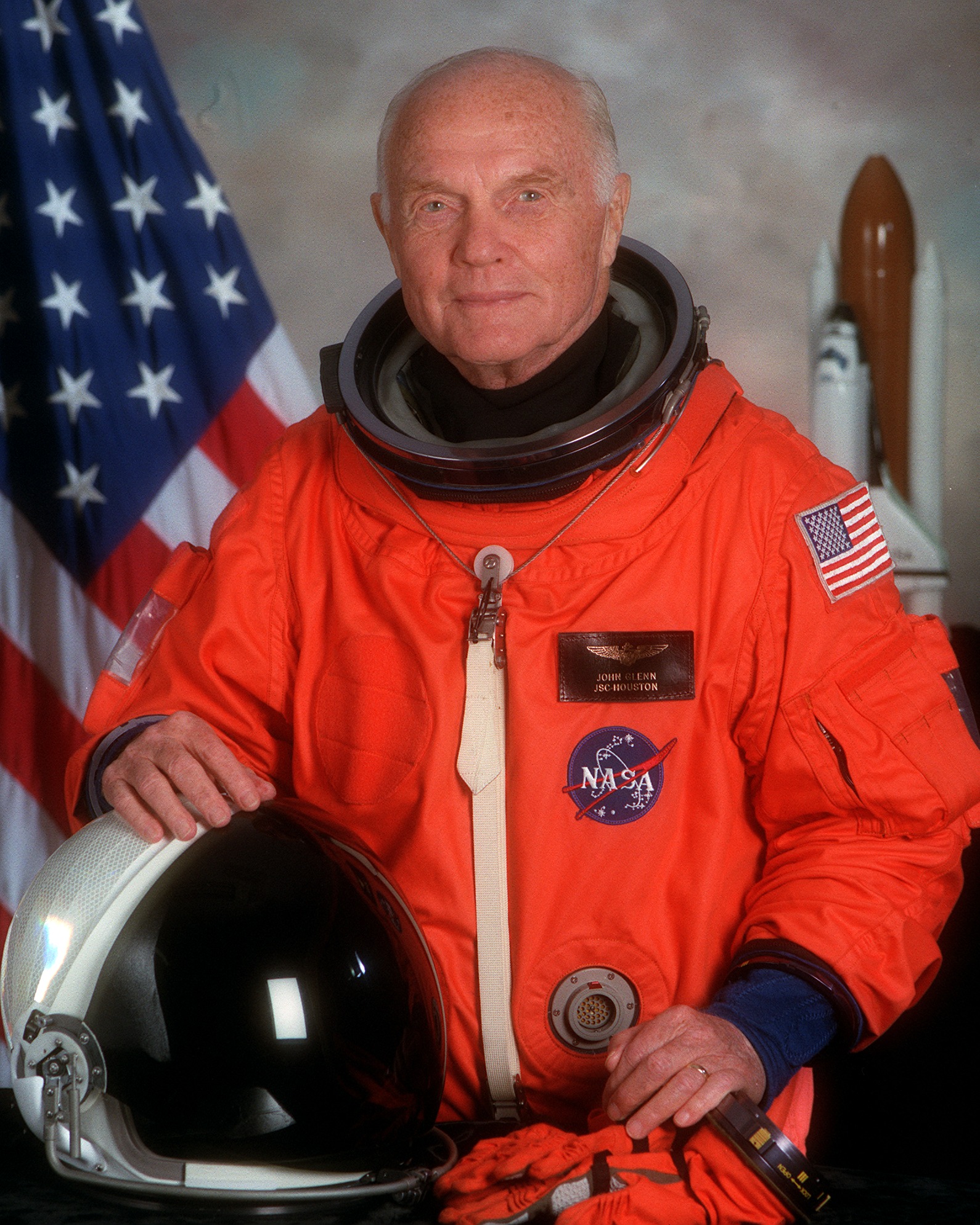 Portrait of STS-95 Payload Specialist Glenn wearing the orange partial-pressure launch and entry suit.