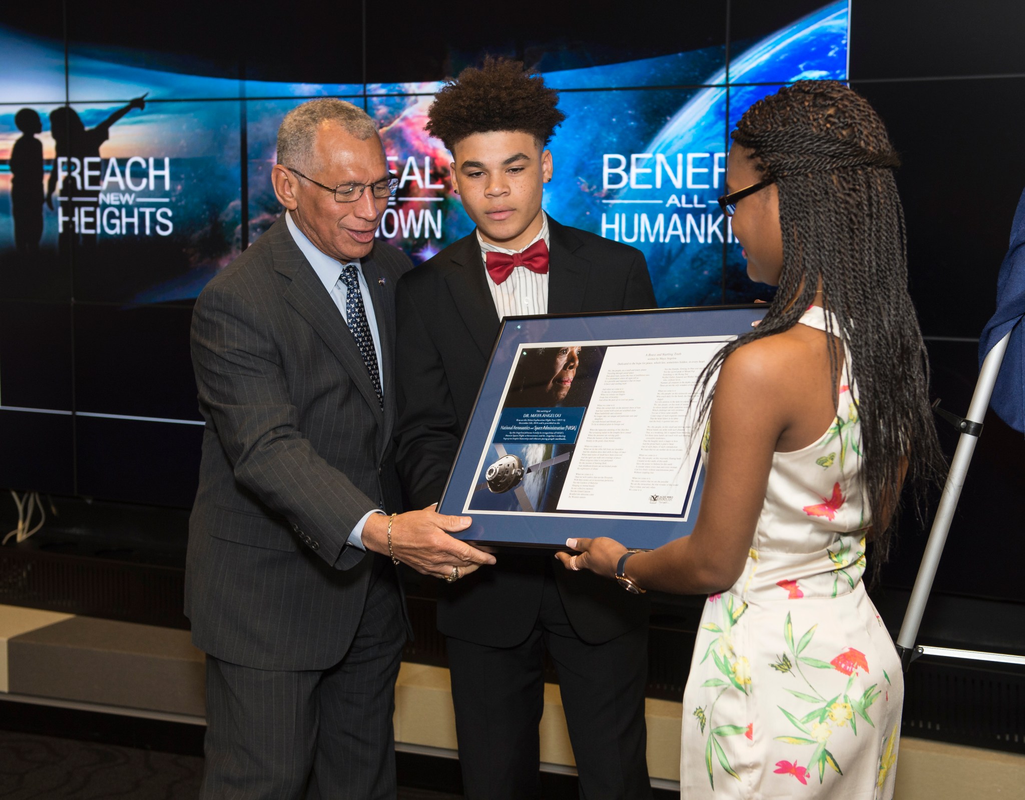 NASA Adminstrator Bolden accepts framed piece of writing with image