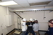 Workers pull cable out of the Vehicle Assembly Building.