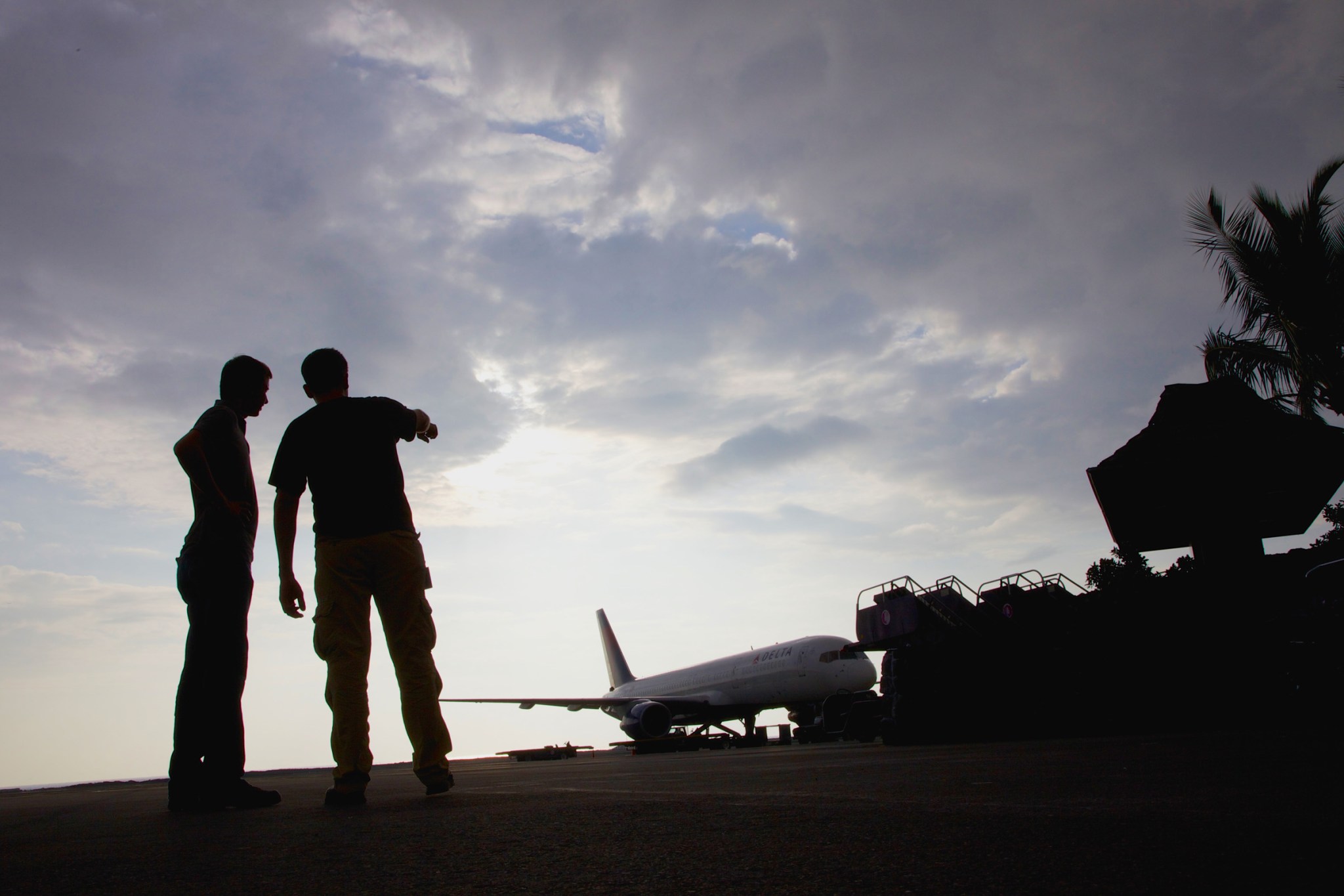 Silhouette image of two people at Kona Airport in Hawaii.