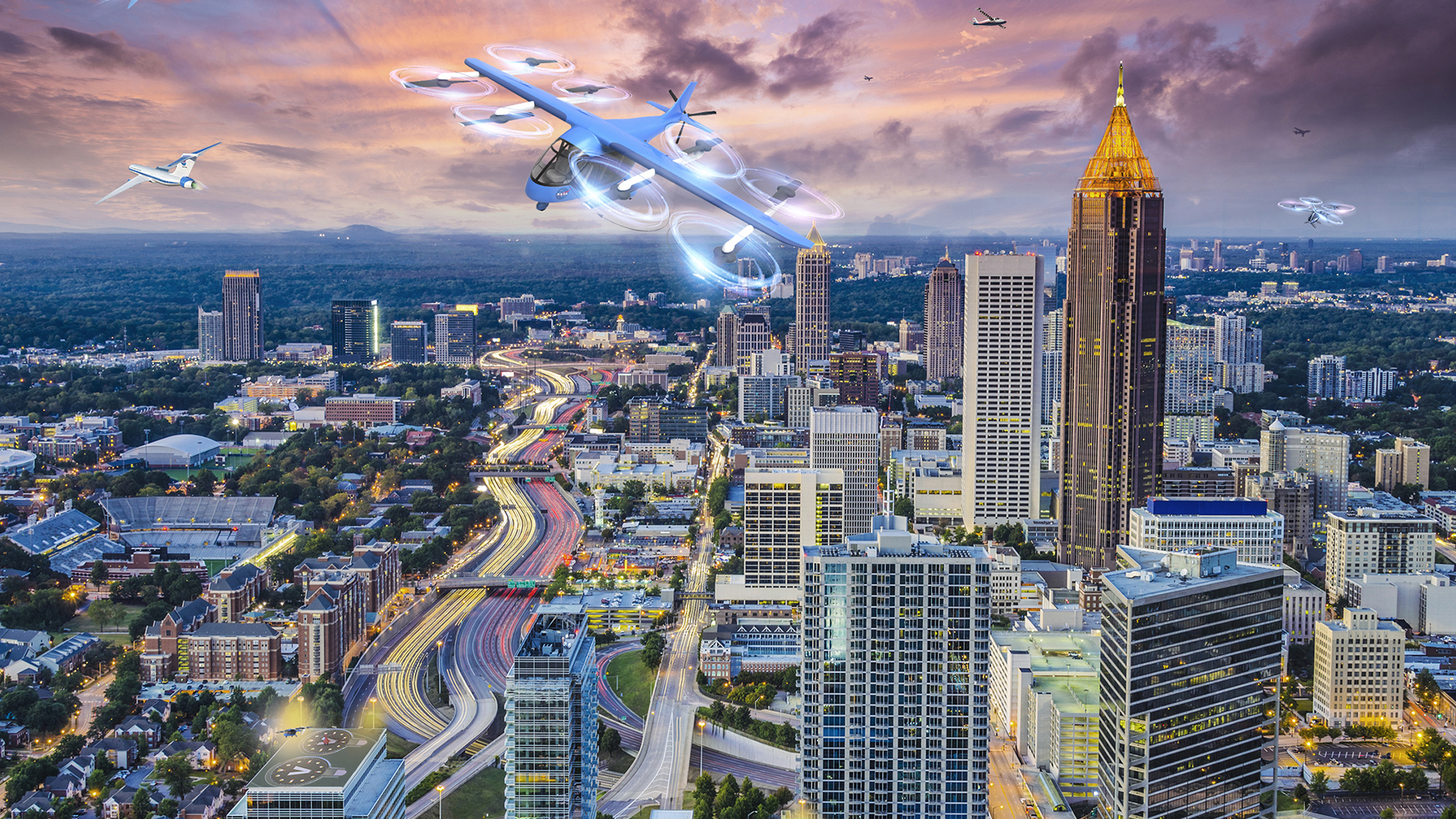Artist concept of urban air mobility vehicles in flight over a city.