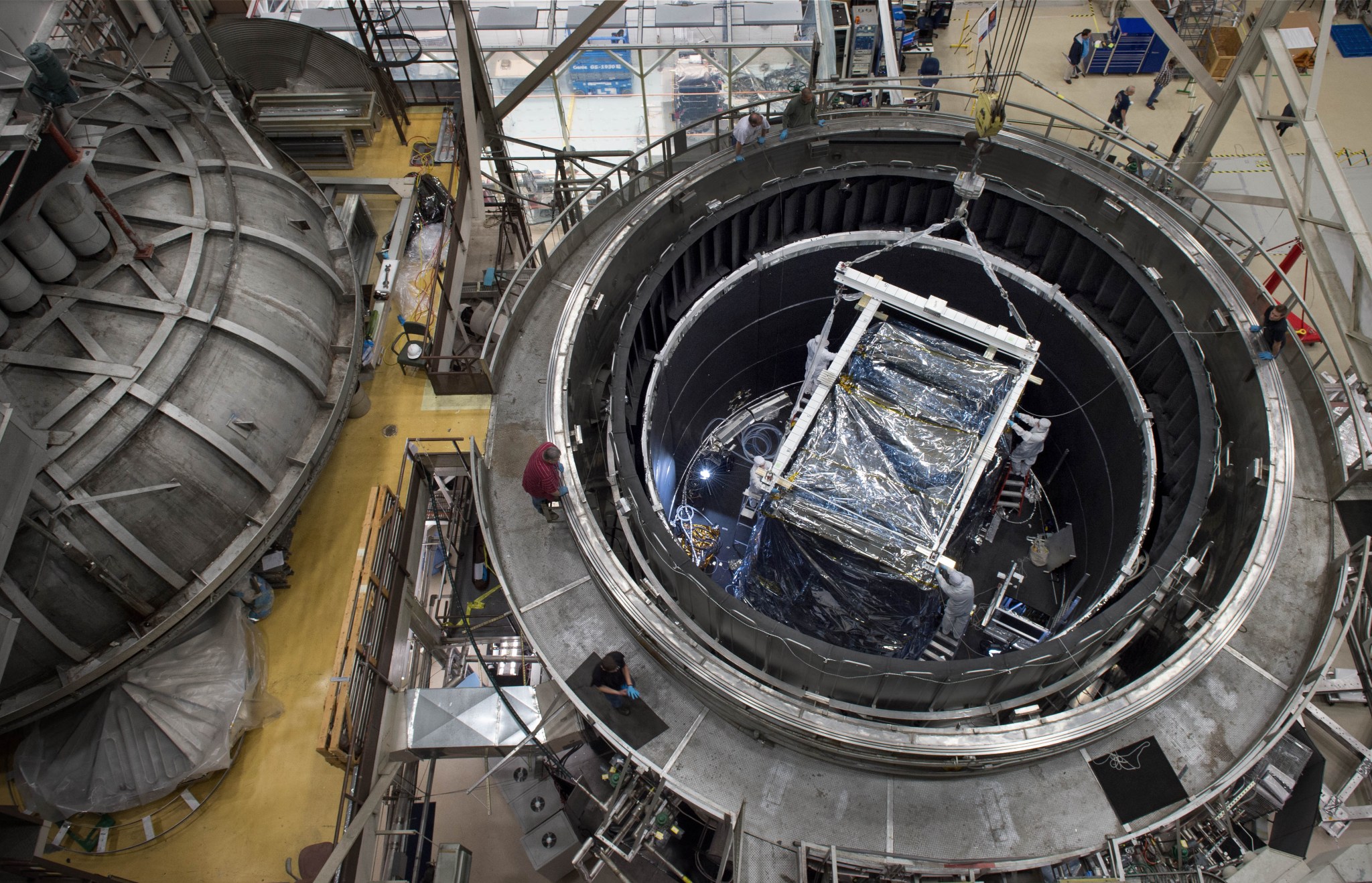 A crane lifts the heart of the James Webb Space Telescope from the Goddard Thermal Vacuum Chamber where it spent weeks in a space-like environment.