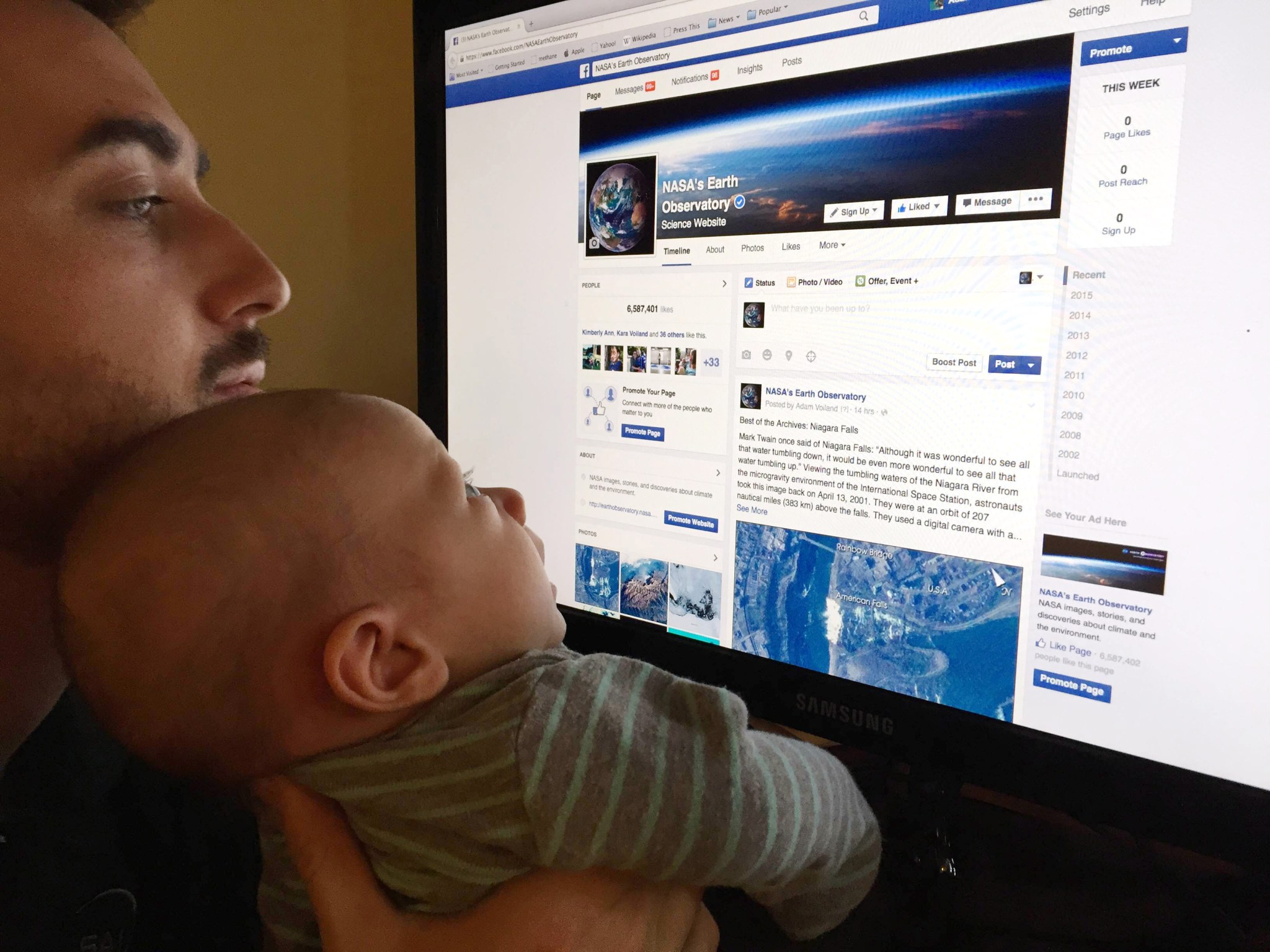 Voiland and son, Calvin, checking out the Earth Observatory Facebook page.