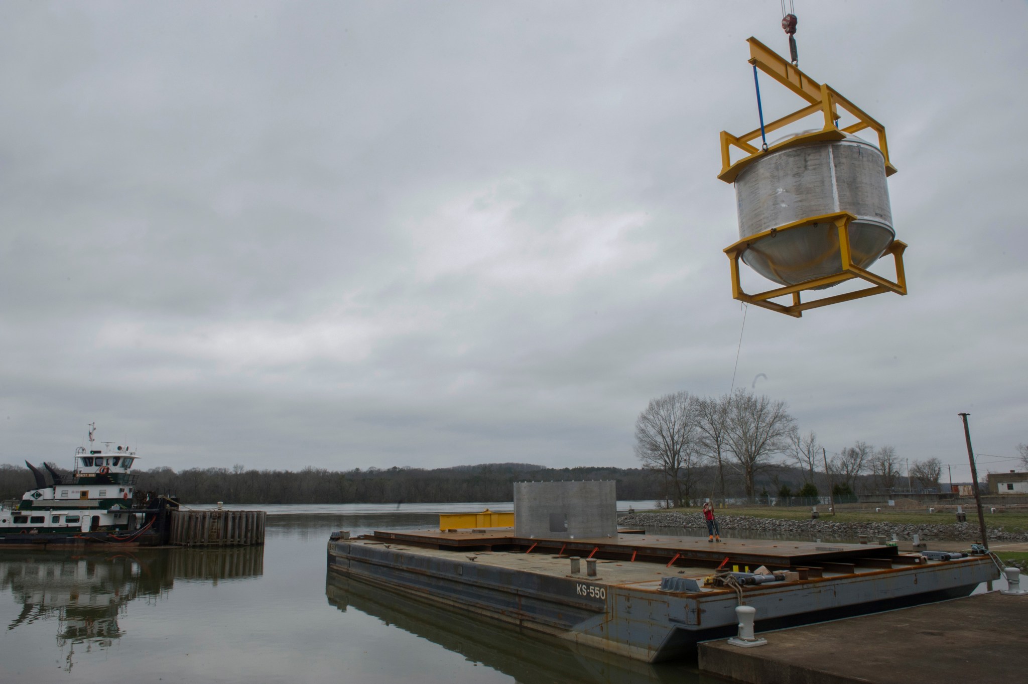 Crews lower the cryogenic tank onto a barge March 12 at NASA's dock on the Tennessee River. 