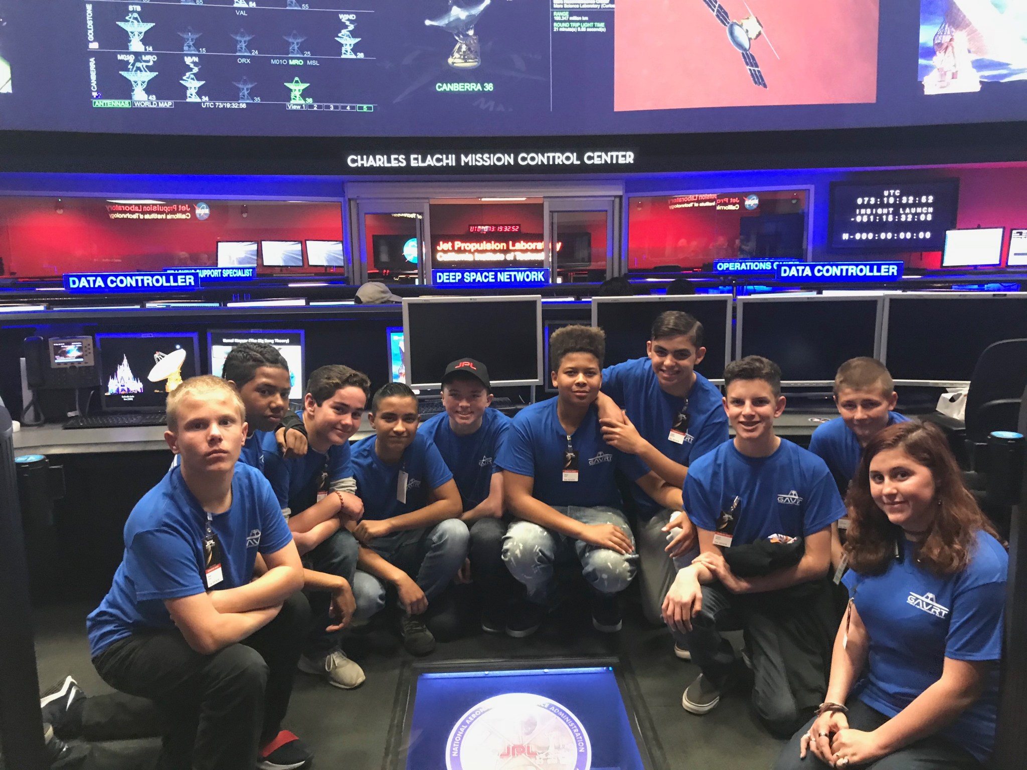 A group of Goldstone Apple Valley Radio Telescope (GAVRT) students sit inside the Charles Elachi Mission Control Center at NASA's Jet Propulsion Laboratory in California.