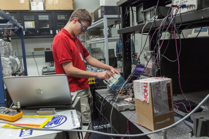 student in lab with scientific instruments 