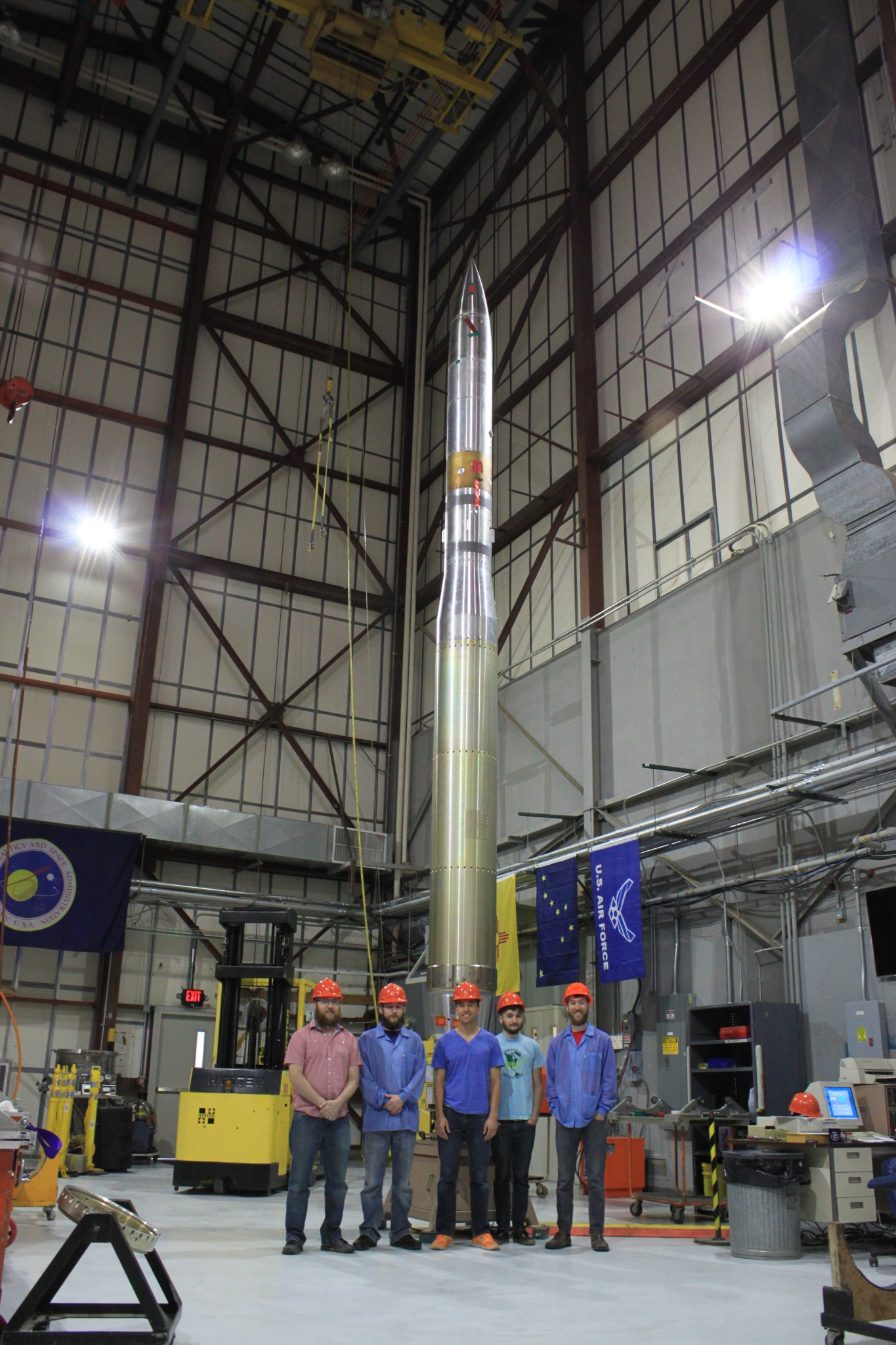 The McEntaffer team stands in front of the OGRESS sounding rocket during its spin balance test.