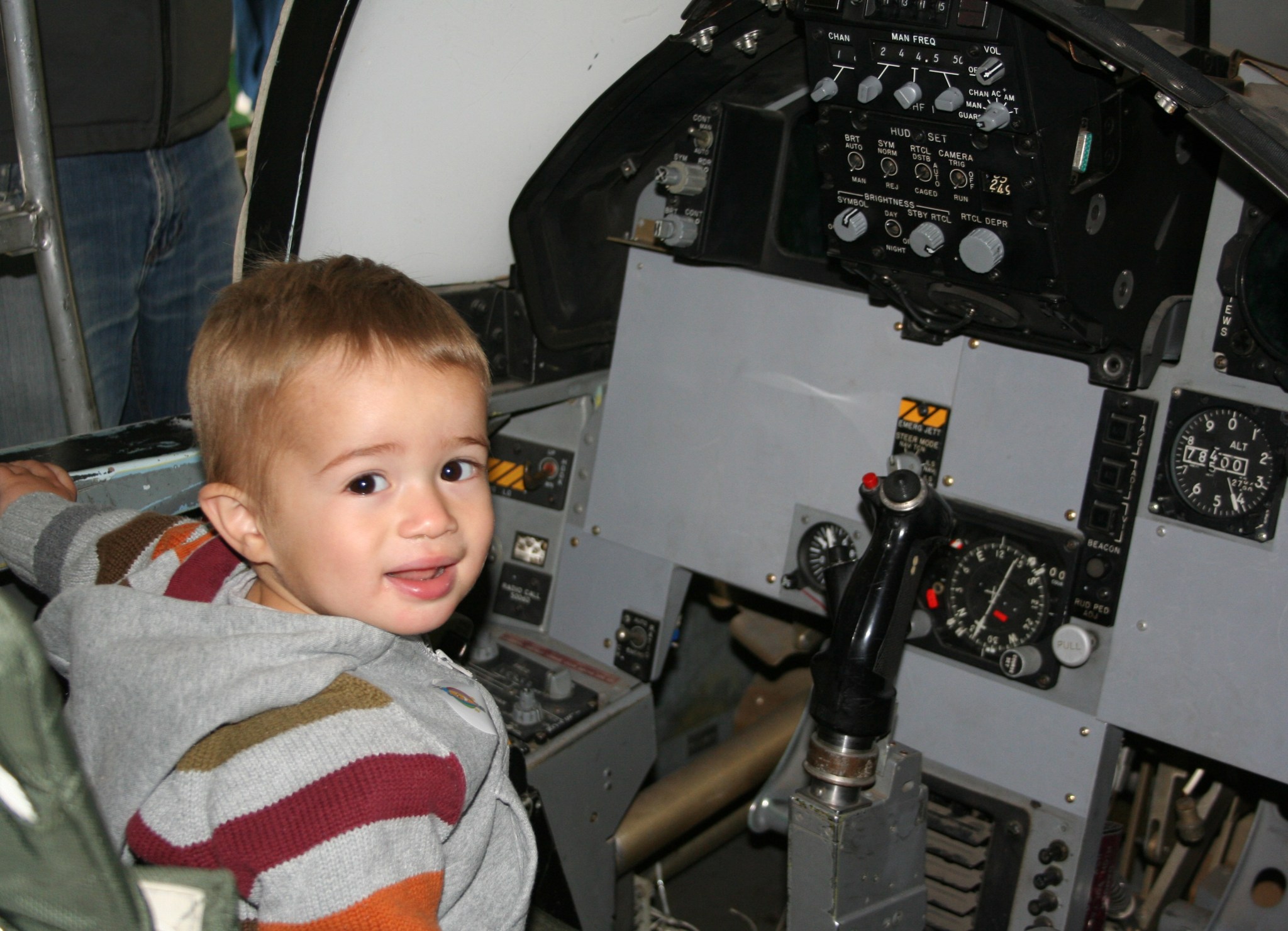 18-month-old Jude Diaz learns what it’s like sit in an F-15 cockpit simulator.