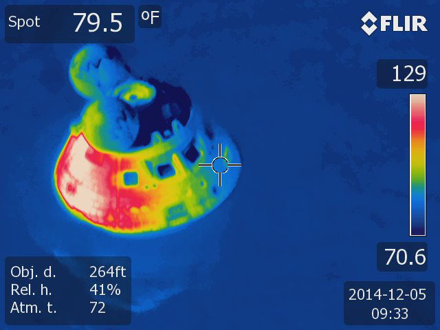 An infrared image shows the Orion crew module floating in the water about 600 miles southwest of San Diego at the end of its 201