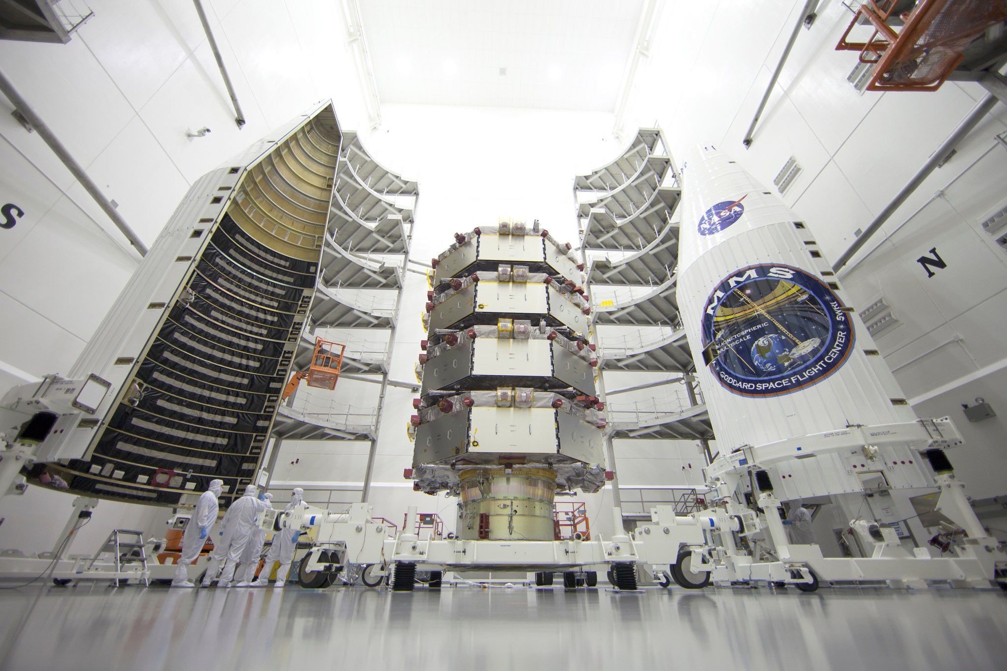 four stacked spacecraft about to be enclosed in faring