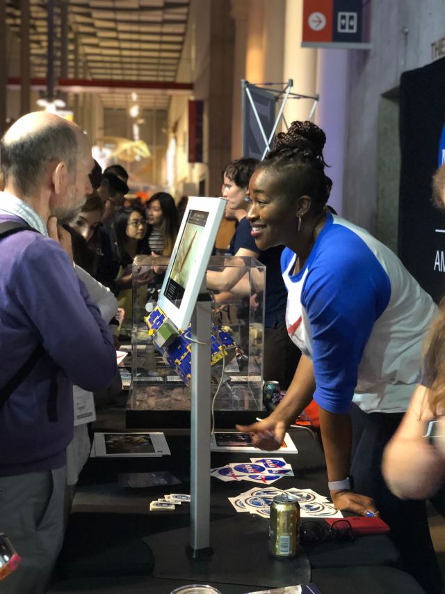 Man visits a NASA booth at a public engagement event.