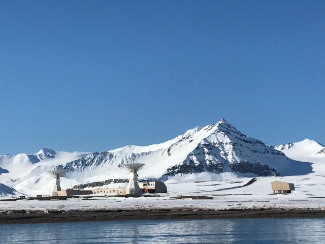 Snowy mountain backdrop behind NASA facility