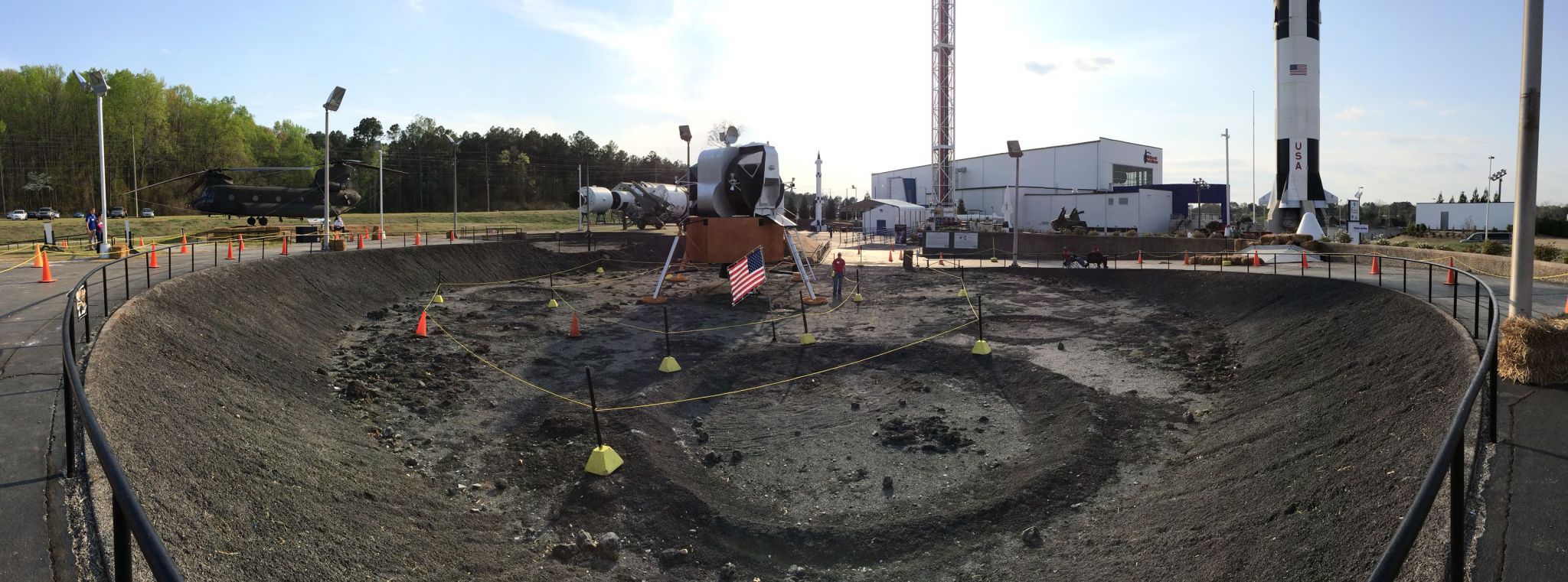 A man stands next to a race obstacle in a fake crater.