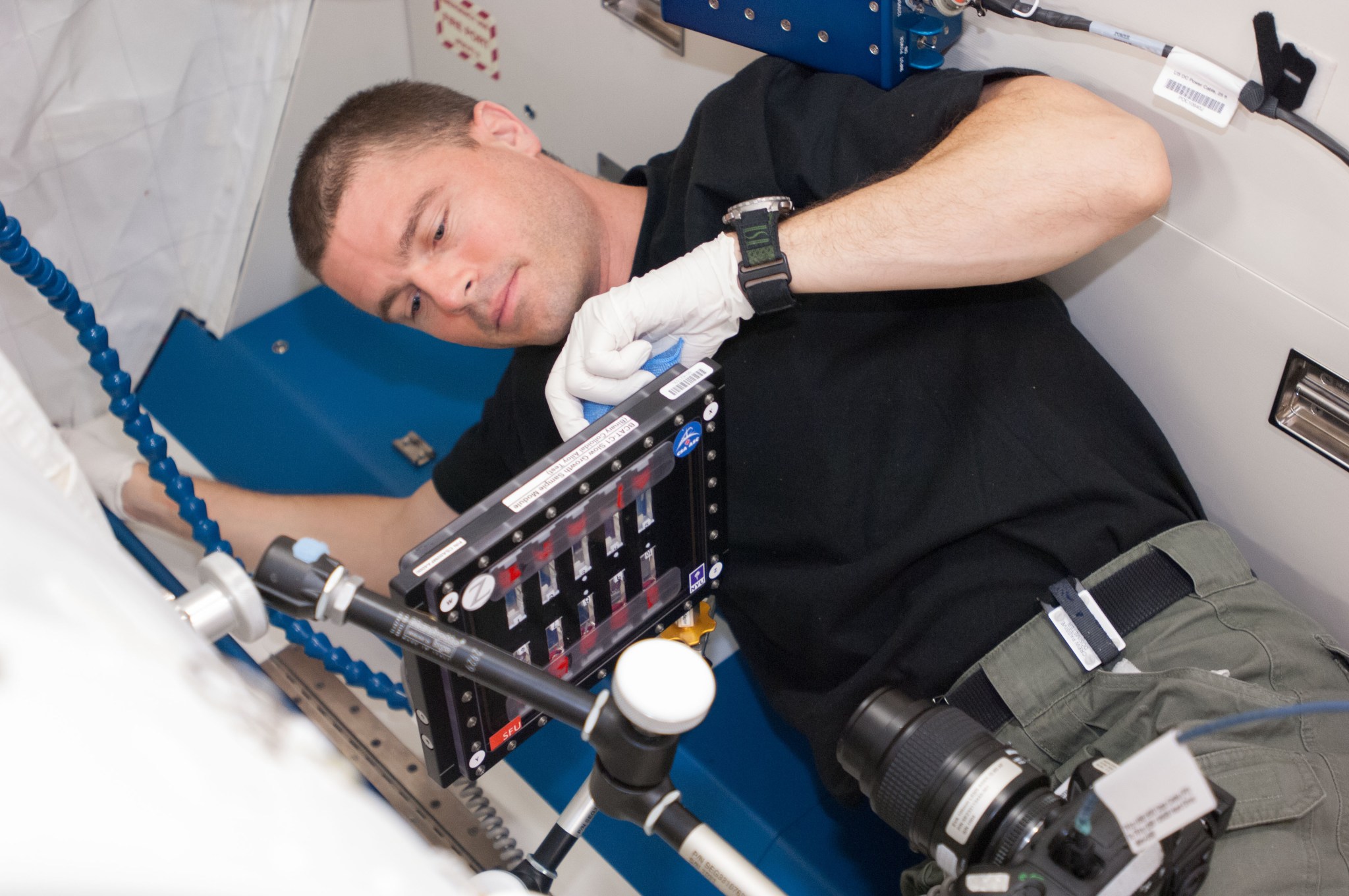 NASA astronaut Reid Wiseman conducts a session with the Binary Colloidal Alloy Test-C1 experiment.