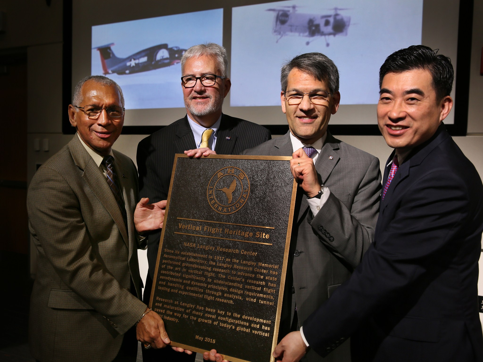 Leaders pose with the plaque naming NASA Langley as an AHS heritage site.