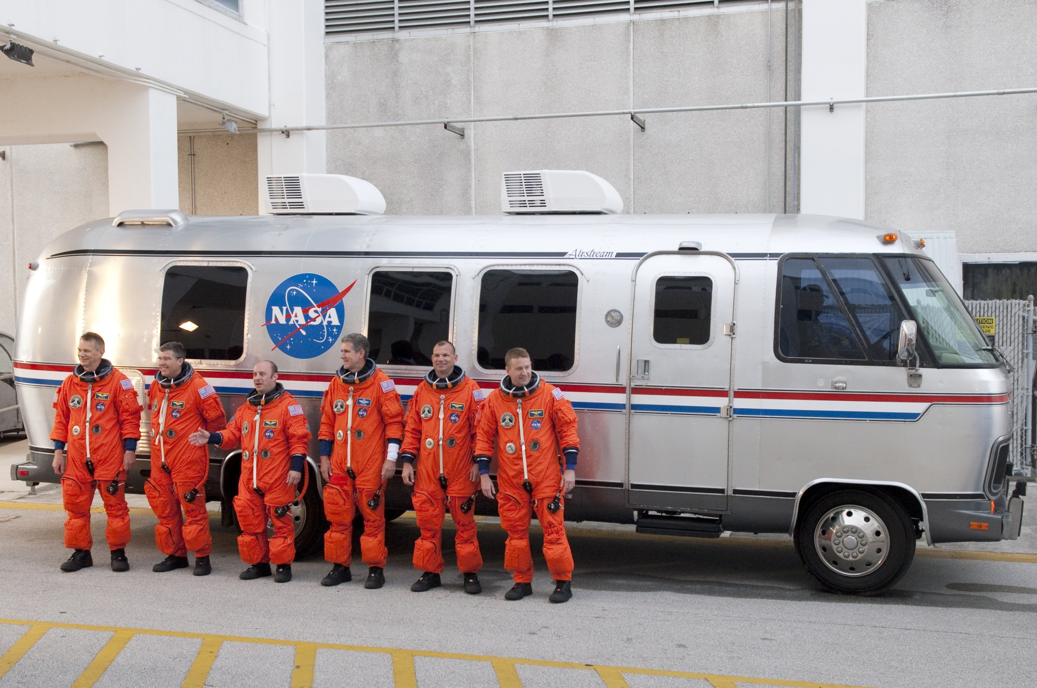 The crew of shuttle Atlantis' STS-132 mission poses for a group portrait in front of the Astrovan.