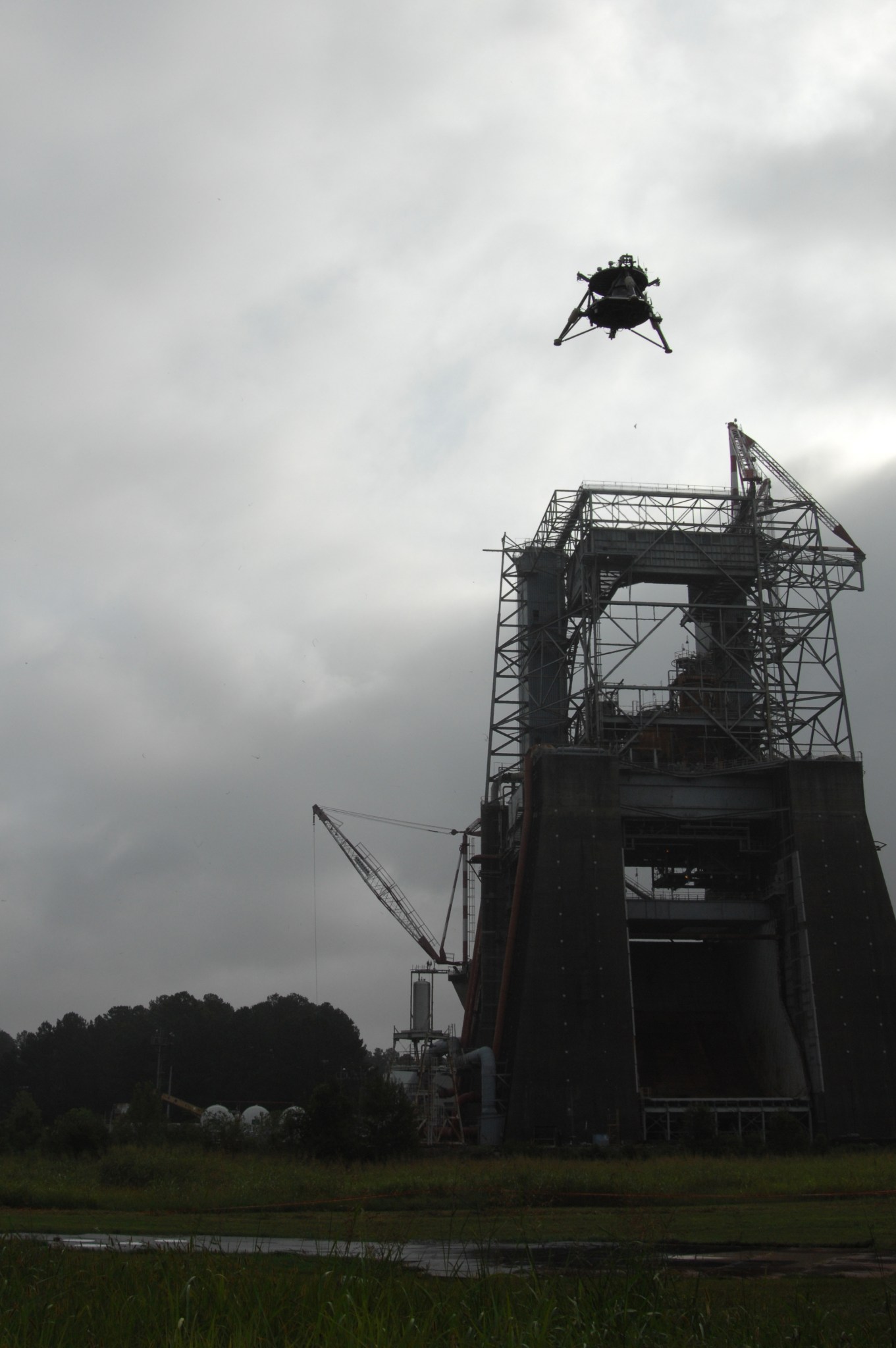 Overcast skies didn't deter the "Mighty Eagle," flying high above the historic F-1 test stand – formerly used to test turbopumps for Saturn first stage engines.