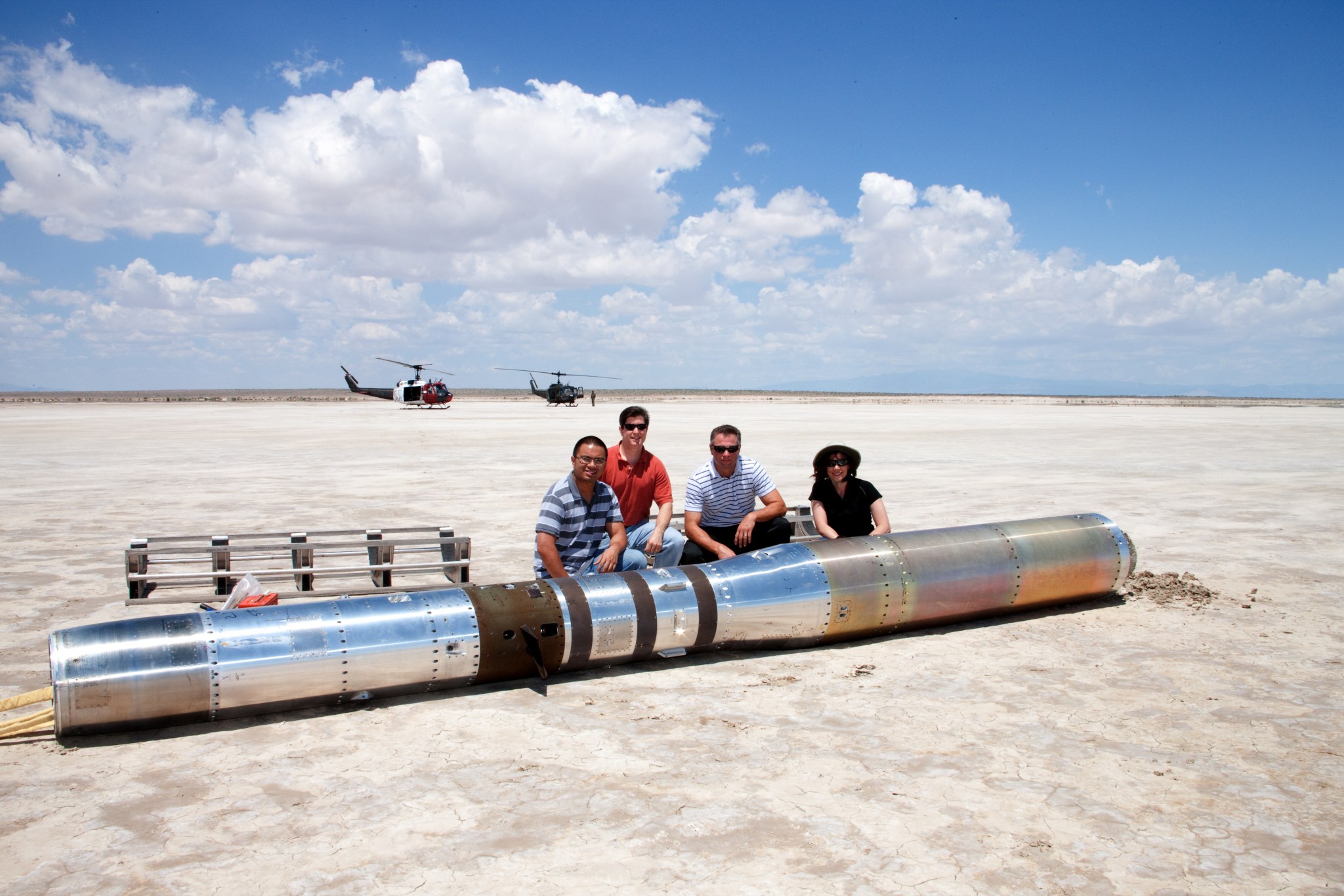 The recovering team poses for a photo with the payload before loading the instrument in a pair of U.S. Army Helicopters and returning to base.