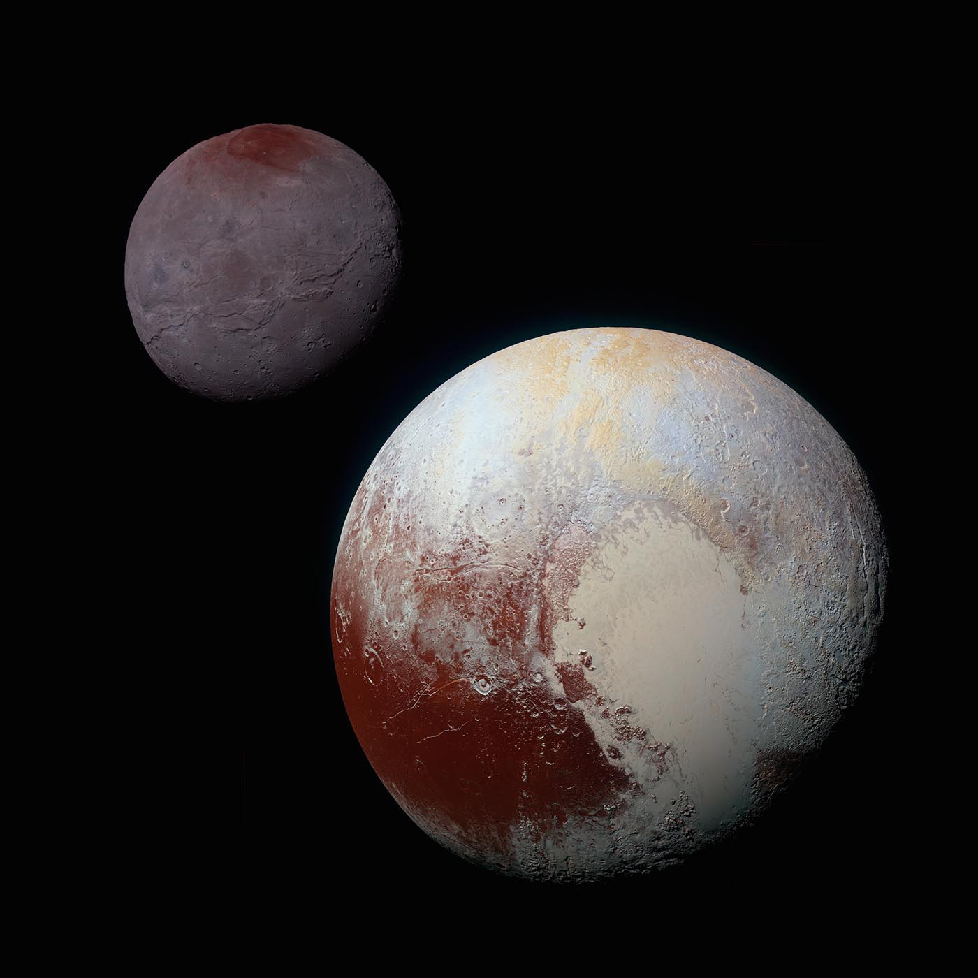 Close-up view of Pluto shows the dwarf planet has a light-colored patch shaped like a heart. Charon is shown behind Pluto.