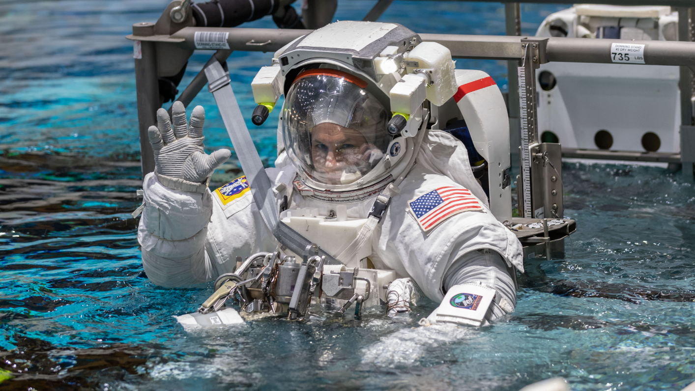 Boeing Commercial Crew Program astronaut Josh Cassada waves before entering the pool at the Neutral Buoyancy Laboratory for ISS EVA training in preparation for future spacewalks while onboard the International Space Station at the Johnson Space Center April 12, 2019 in Houston, Texas.
