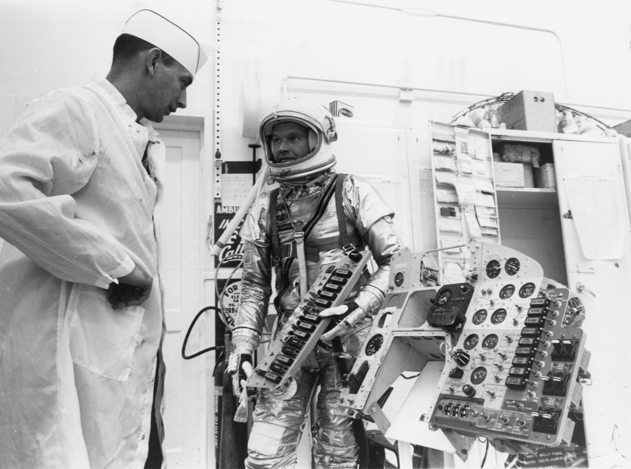 Astronaut L. Gordon Cooper Jr., checks over the instrument panel from Mercury Spacecraft No. 20
