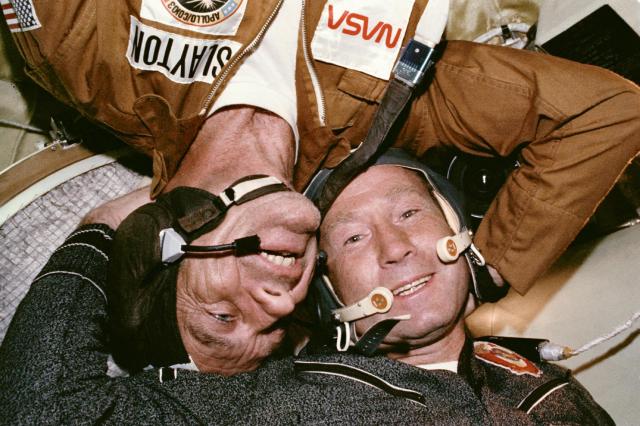 Astronaut Donald K. "Deke" Slayton embraces cosmonaut Aleksey Leonov in the Soyuz spacecraft.