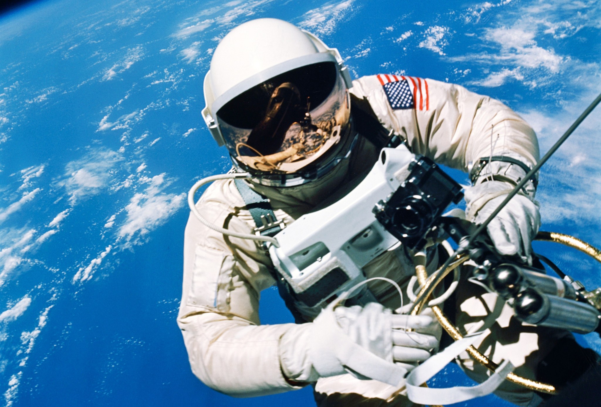 Astronaut Ed White floats in the microgravity of space outside the Gemini IV spacecraft.