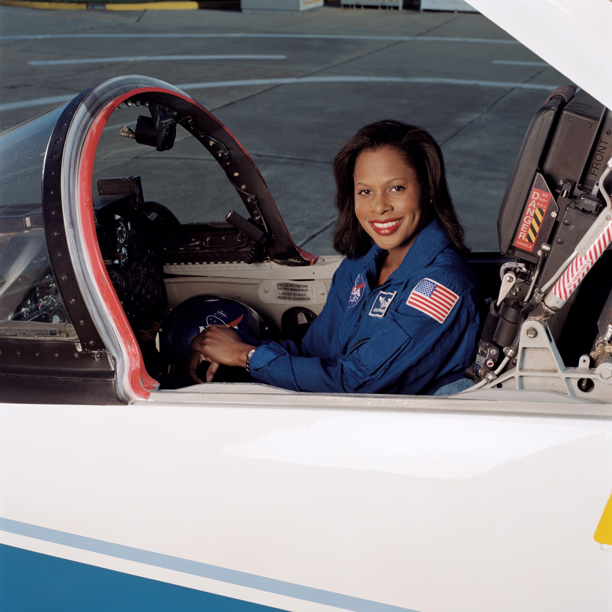 Astronaut Joan Higginbotham sits in the cockpit of a small jet