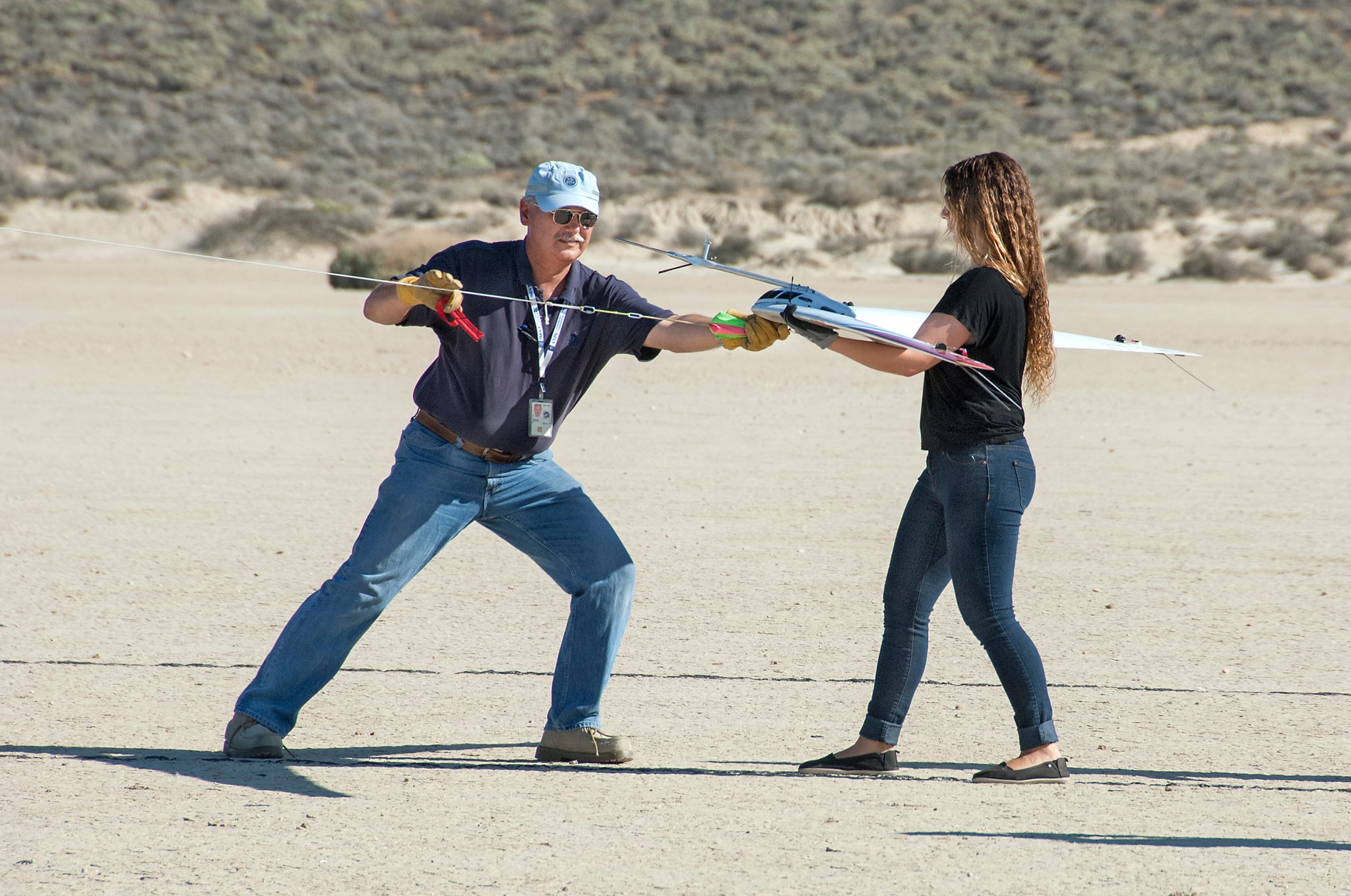 Al Bowers attaches a bungee cord to the Prandtl-d, as Kassidy McLaughlin prepares to release and launch the aircraft.