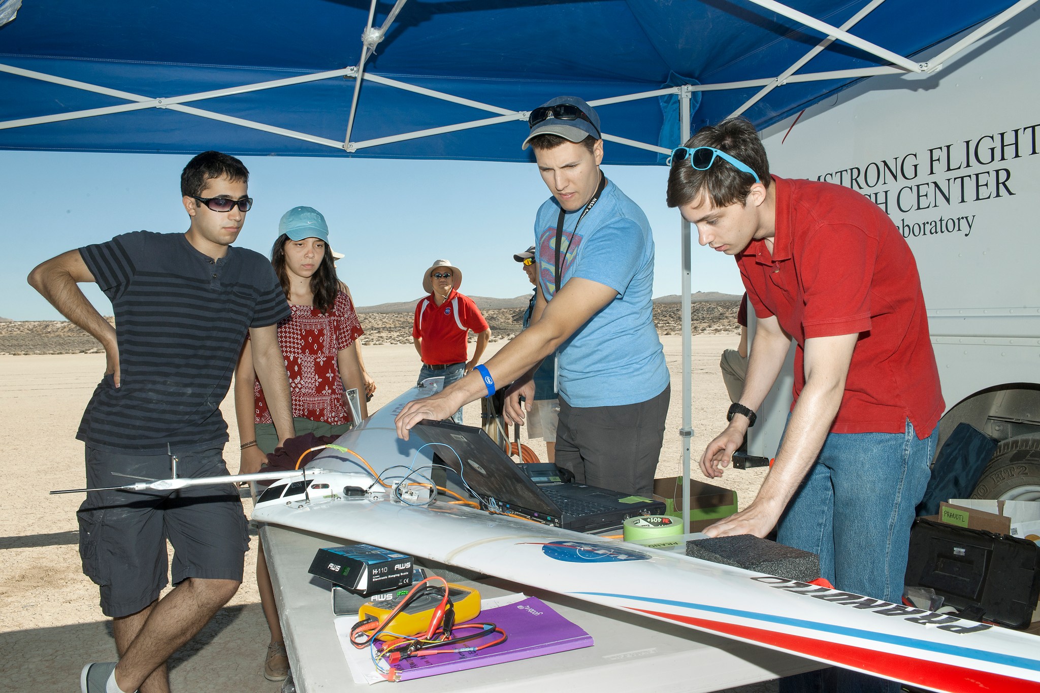 Students and engineers wait for data to download from a Prandtl-d flight.