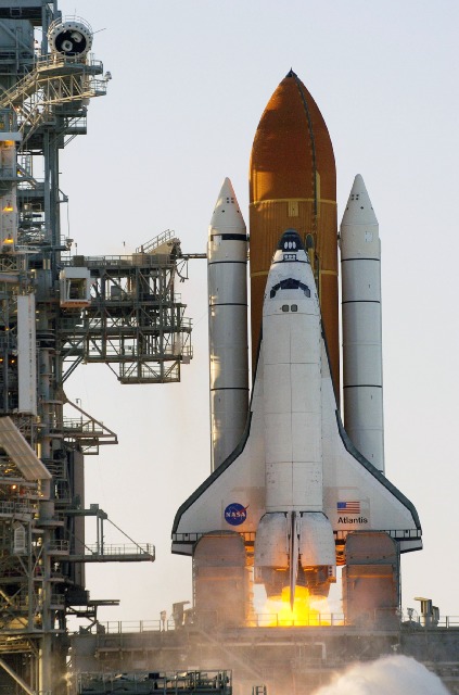 Picture of a space shuttle launching in an upright position