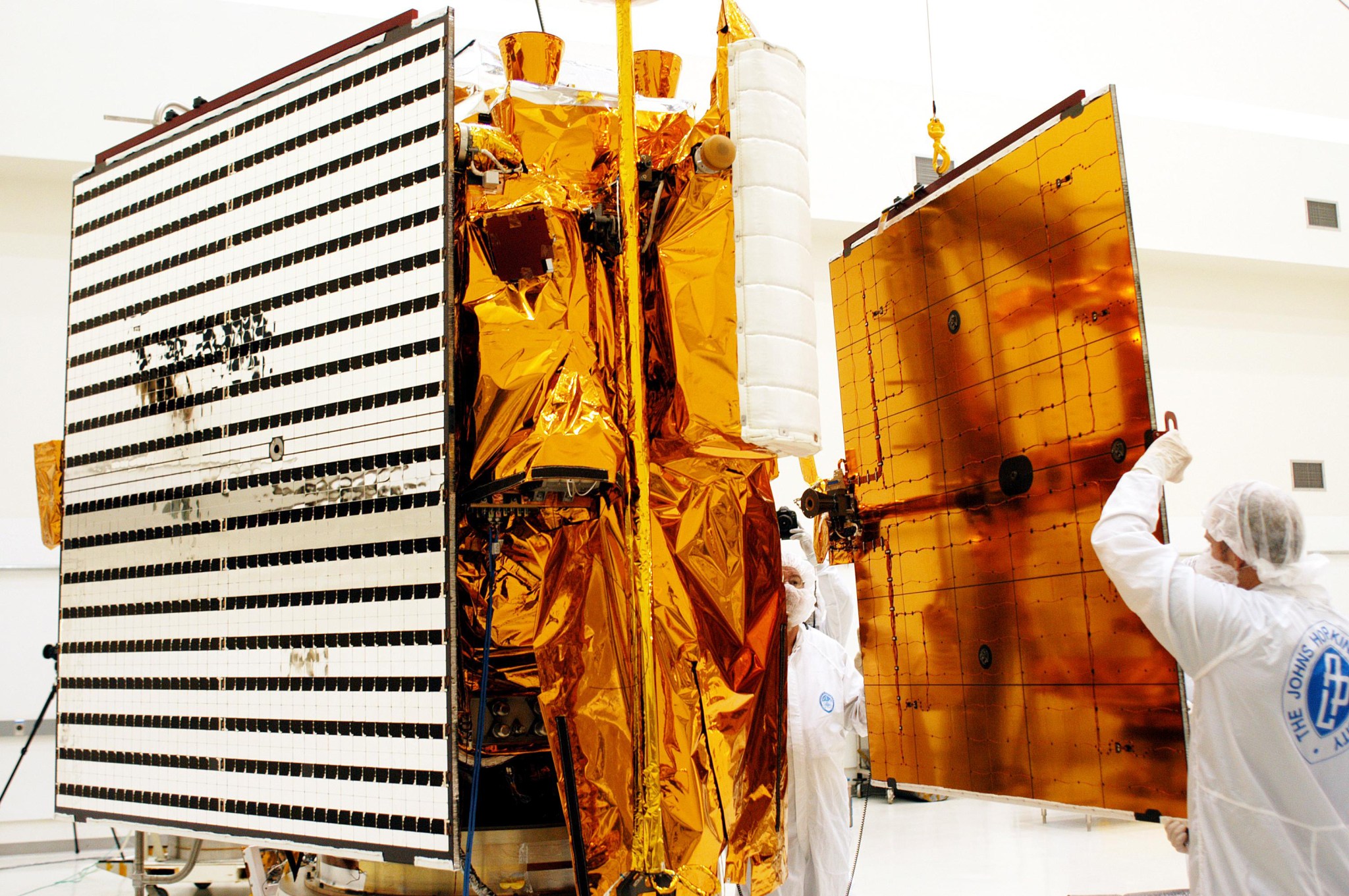 Workers put a solar panel onto NASA's MESSENGER spacecraft