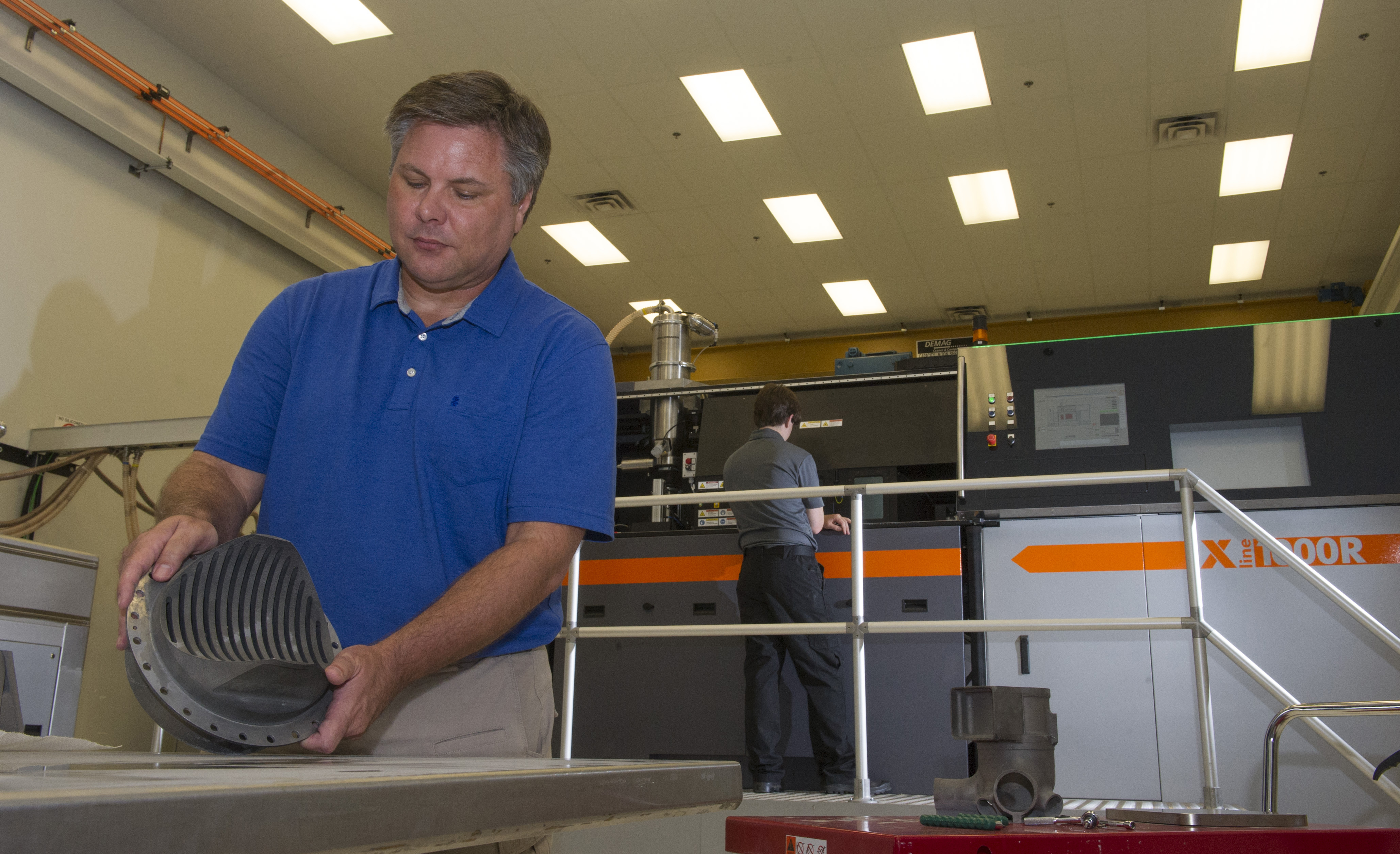 Andy Hardin inspects a 3-D printed rocket part made with a selective-laser-melting machine in the Advanced Manufacturing Lab. 