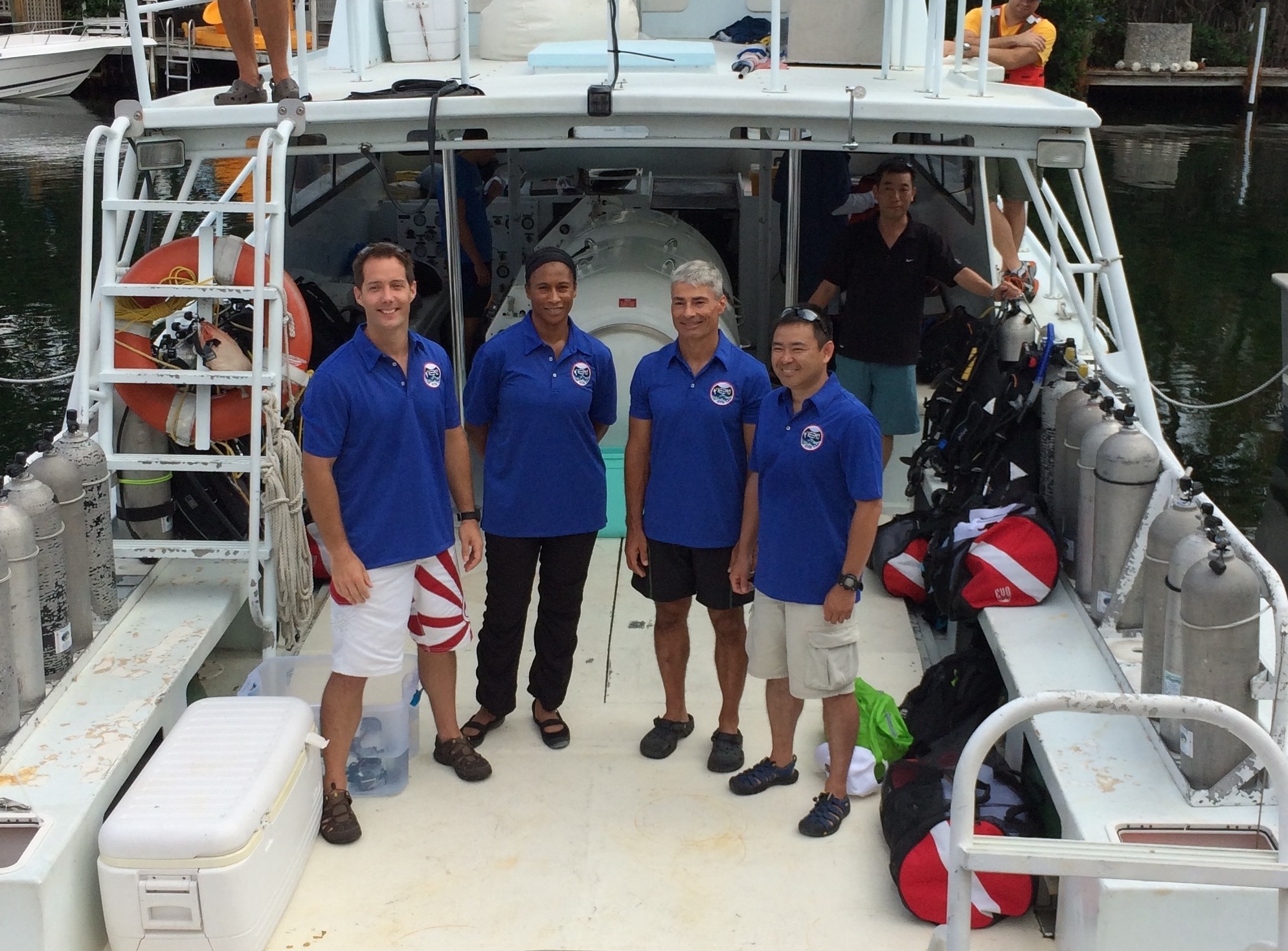 Photo of astronaut crew headed out on a boat to Aquarius Habitat for NEEMO)