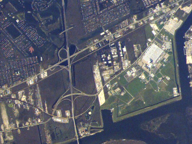 In this image acquired from the ISS on Sept. 8, 2005, areas damaged by Hurricane Katrina surround NASA's Michoud Test Facility.