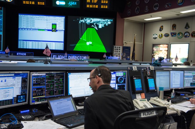 Station Flight Director Chris Edelen Monitors SpaceX Dragon