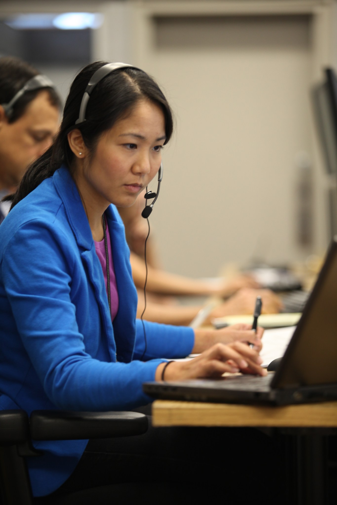 Josephine Santiago-Bond is stationed at the payload console position in a control room in Firing Room 4.